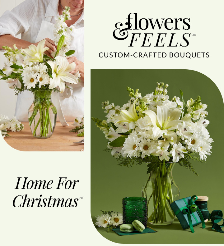 A split-image featuring a florist arranging a bouquet on the left, with a focus on her hands gently placing white lilies and greenery into a clear glass vase. She is wearing a white apron over a light-colored blouse. On the right, a fully assembled bouquet is displayed, consisting of white lilies and a variety of white flowers, set in the same style of clear vase. Accompanying items include a green candle, macarons on a square plate, and a gift wrapped in green paper with a teal ribbon