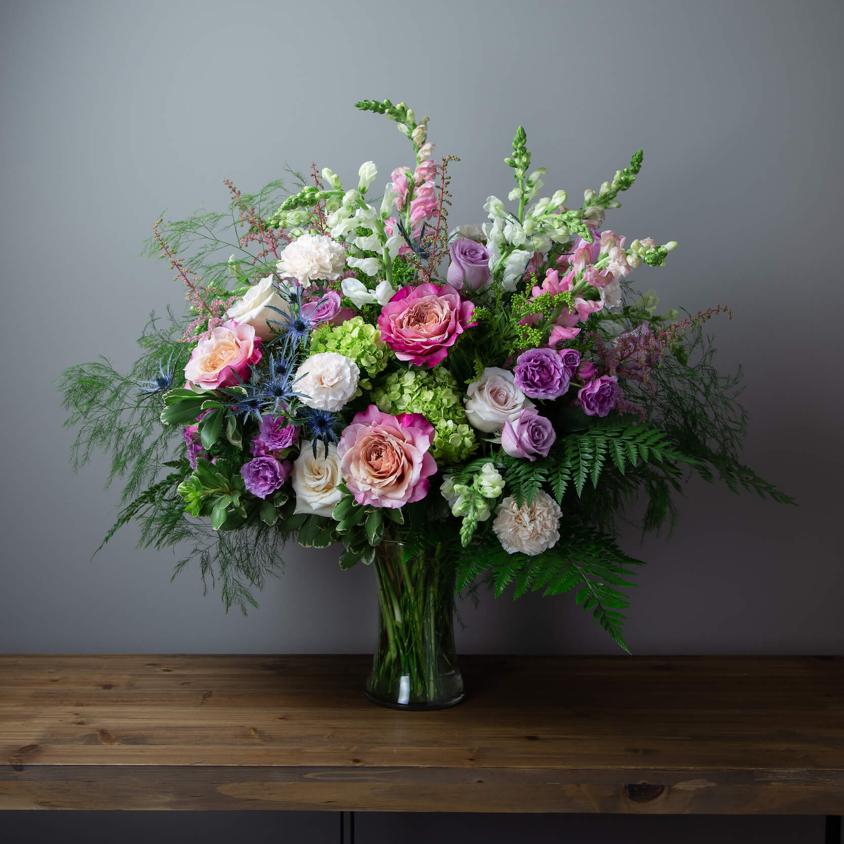 talk floral arrangement in the shades of white, Lavender, pinks, and blues