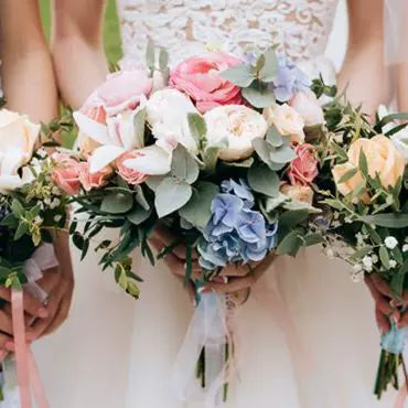 A picture of a bride and bridesmaid all holding their wedding bouquet