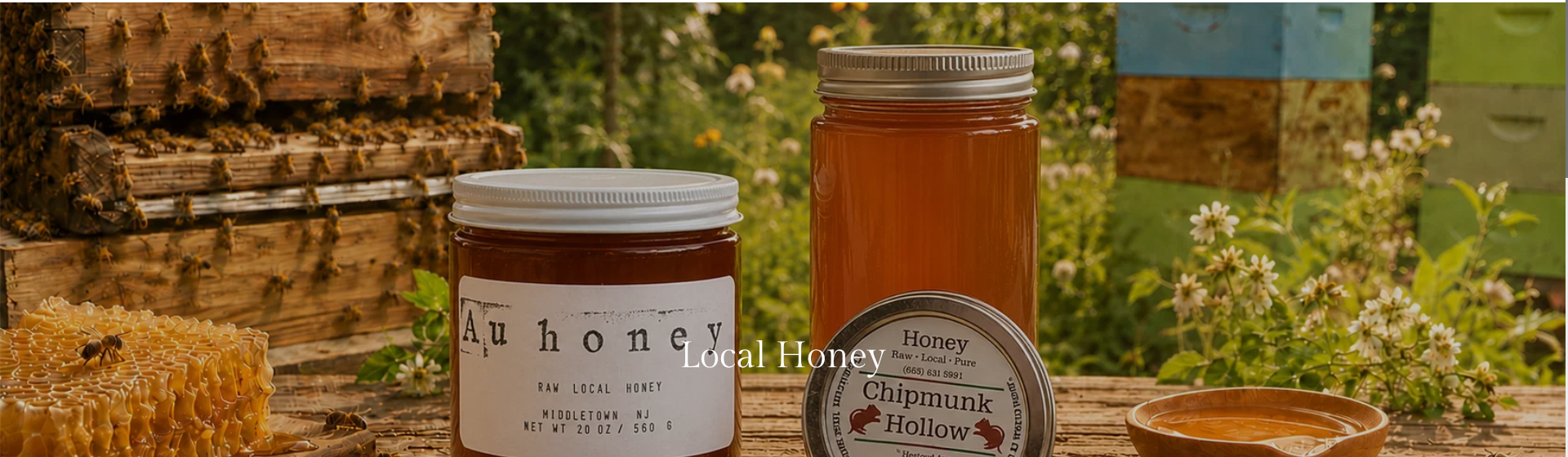 Jars of local honey among bee hives and flowers